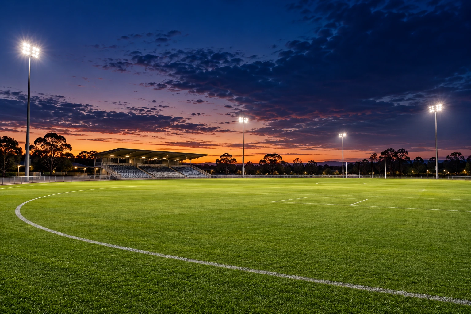 Illustrative floodlit sports oval at twilight